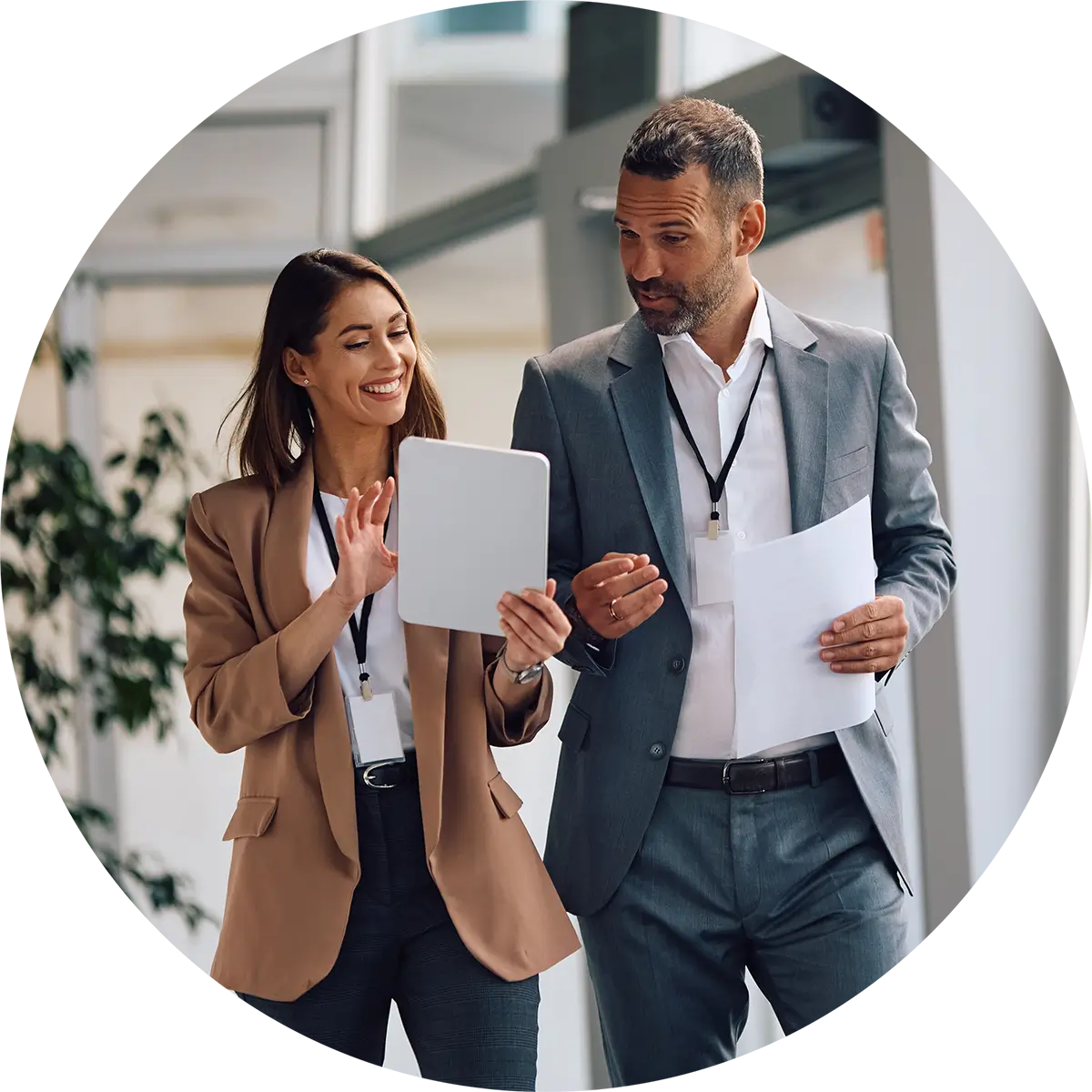 Two colleagues discussing documents at the office