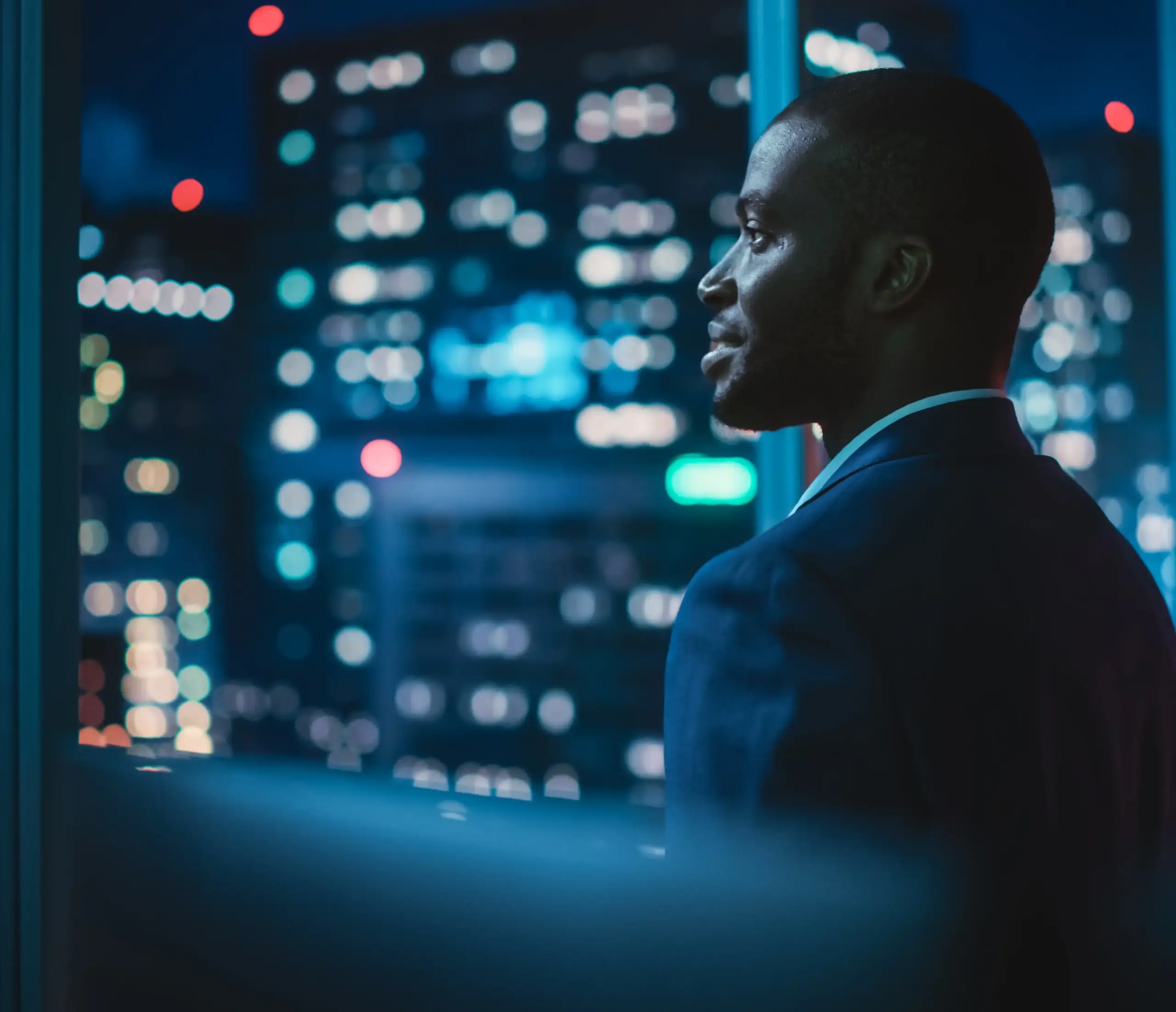 Man looking out the window in the city